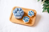 Artisan ceramic paw-shaped decor pieces on a wooden tray, perfect for home decoration or gifting.